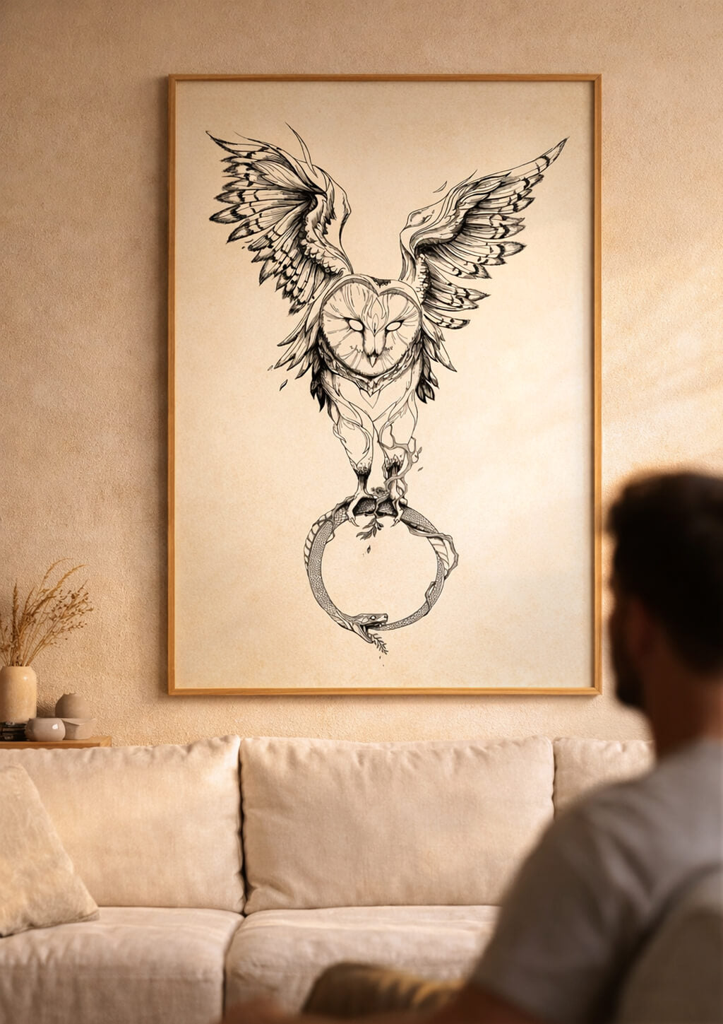 Large owl wall art above sofa in warm neutral living room, blurred man in foreground creating calm and focused atmosphere